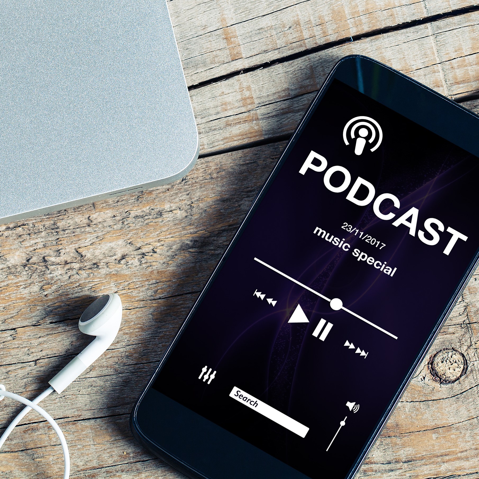 Mobile phone placed on a wooden desk with podcast app in the scr